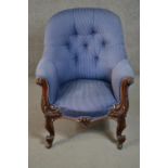 A circa 1830s mahogany tub armchair, upholstered in striped blue fabric, with a button back, the