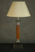 A Classical column style table lamp, with a reeded stem, and nickel plated mounts, on a square