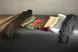 A collection of 19th and early 20th century fabrics, brocades and clothing, including a hand