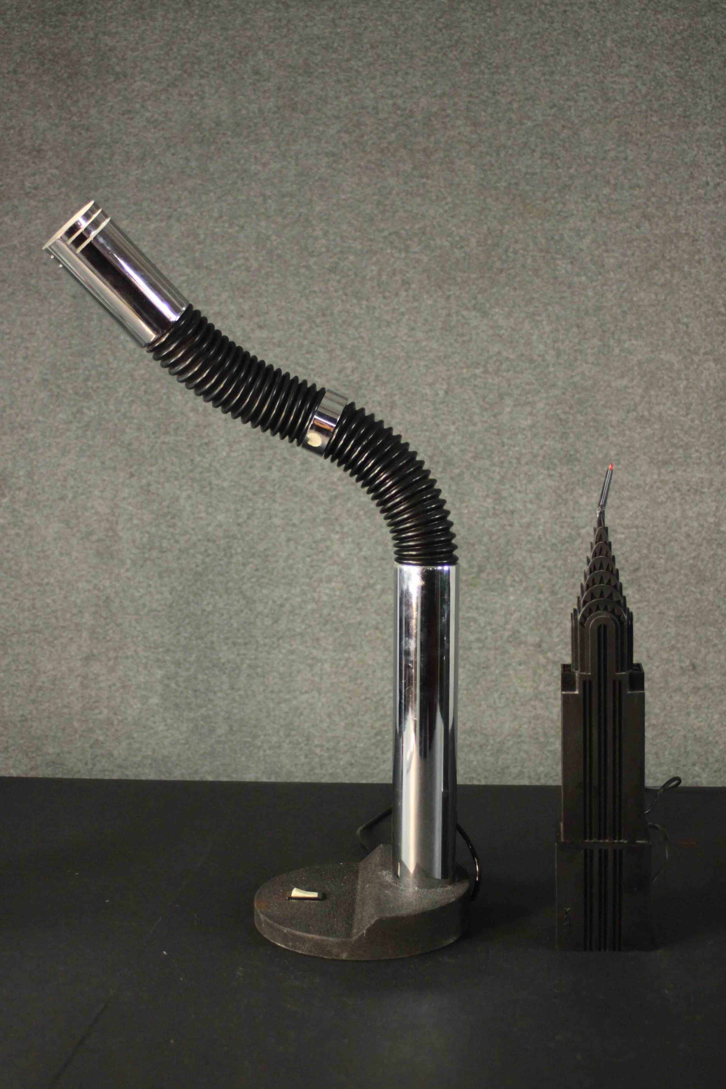 An extending tube and chrome table lamp along with a toy Chrysler building converted to a lamp. H.76