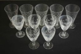 A collection of eleven drinking glasses, including a set of five blown glass hobnail pattern trumpet