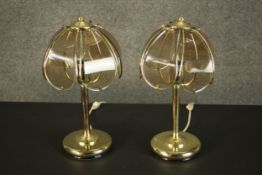 A pair of late 20th century brass table lamps, the shade formed of five smoked glass petals and