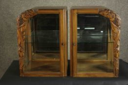 A pair of French 1940s walnut display cabinets, each with a single glazed door, and glazed sides,