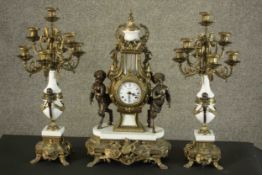 A 20th century Italian gilt metal clock garniture, the clock of lyre form with an enamelled dial
