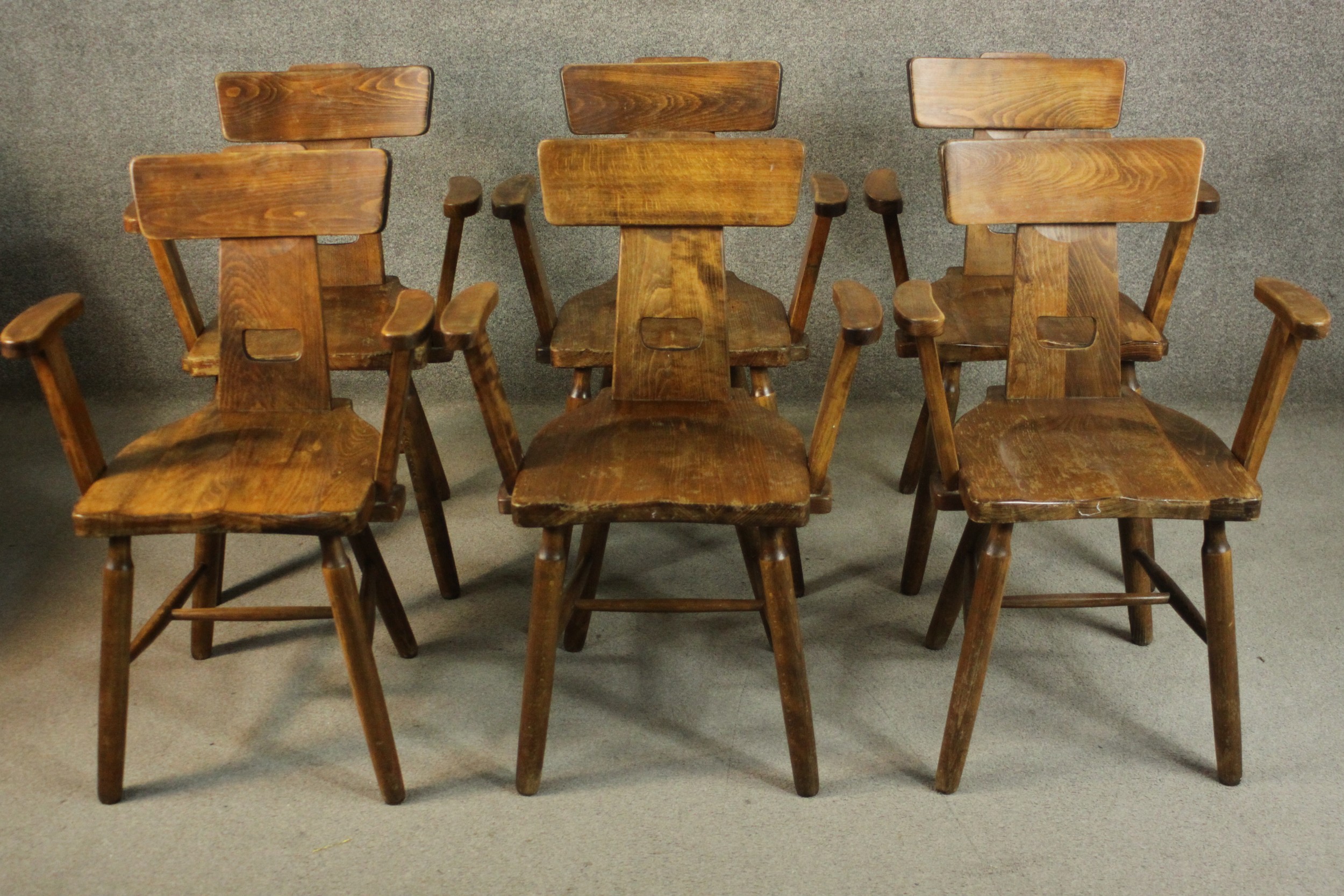 A set of six 20th century country style chairs, with a bar back on a splat with a cutout, over a