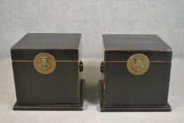 A pair of contemporary Chinese black lacquered storage boxes of cube form with brass handles and