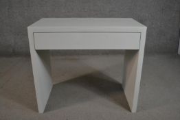 A contemporary white desk of rectangular form with a single frieze drawer on end supports. H.71 W.80