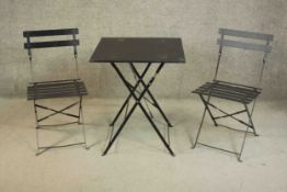 A metal folding garden table and the two matching chairs. Table. H.70 W.60 D.60cm.