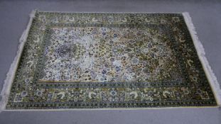 A handmade cream ground Kashmir silk rug. L.180 H.120cm