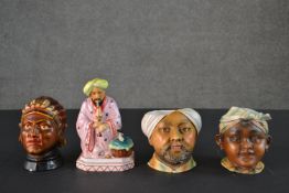 Three hand painted porcelain tobacco jars in the form of heads of various world cultures along