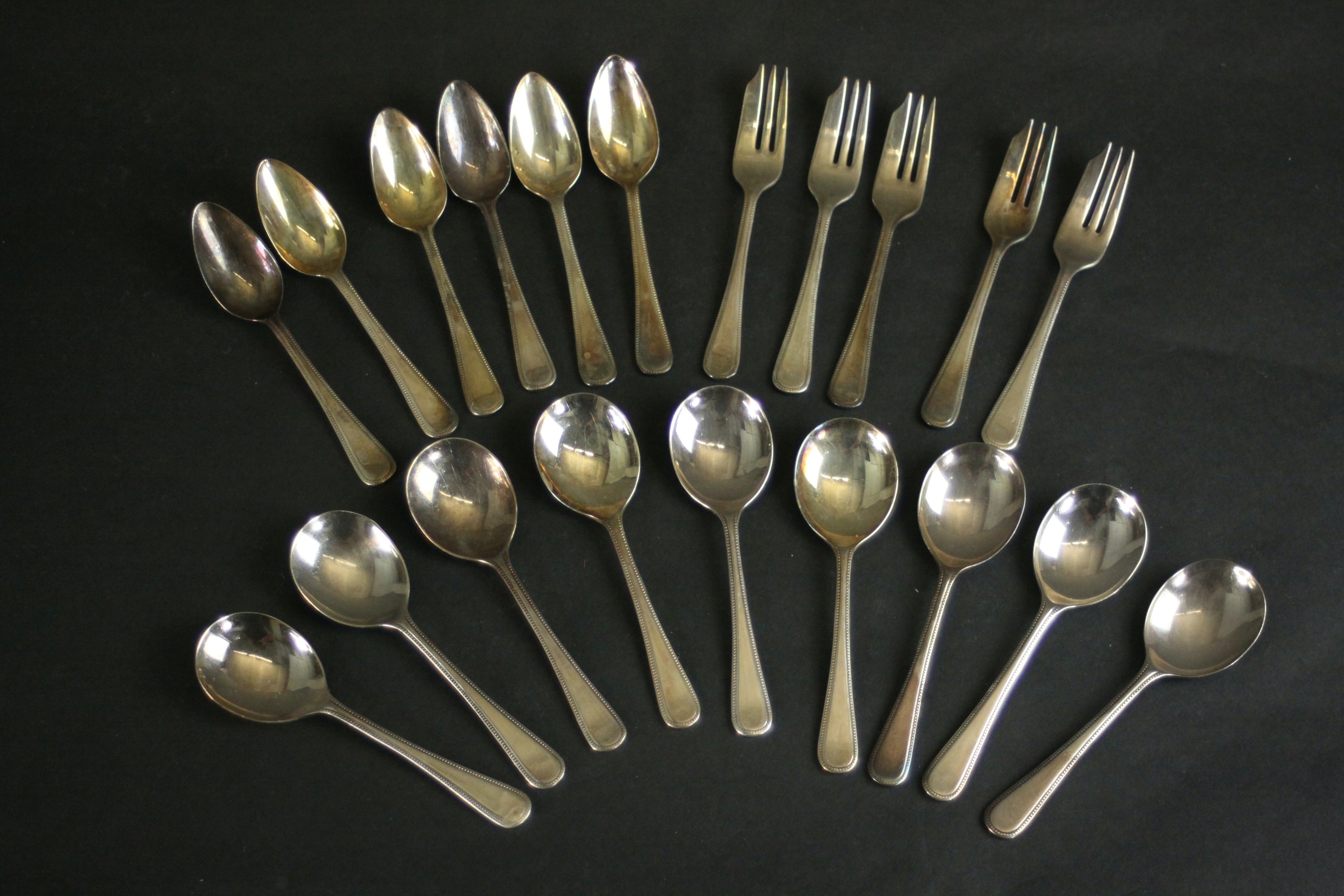 A collection of Harrods silver plated cutlery, including six grapefruit spoons, five fruit forks and