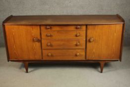 John Herbert for A. Younger Ltd, a circa 1970 Volnay range teak sideboard, with four central drawers