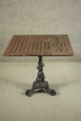 A black painted Victorian cast iron pub table with a later square slatted teak top. 1 H.71 W.80 D.