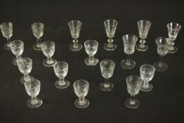 A collection of eighteen hand cut crystal and glass sherry and port glasses, including a set of