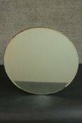 A circa 1940's circular mirror with a plywood back. Dia.47cm.