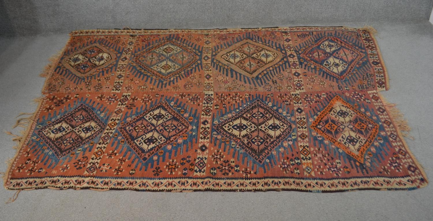 Two joined Persian Kelims, repeating diamond medallions on a burgundy ground. L.232 W.163cm