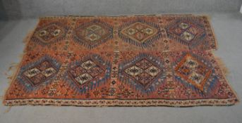 Two joined Persian Kelims, repeating diamond medallions on a burgundy ground. L.232 W.163cm