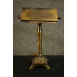 A replica Victorian style banker's brass desk lamp, with a brass shade, a reeded stem on a square