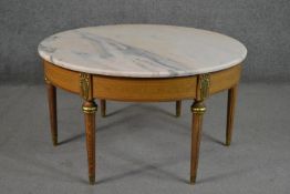 A Louis XIV style circular coffee table, with a marble top over a marquetry key frieze, on