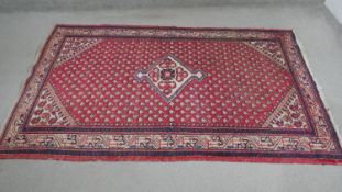 A red ground handmade Persian sarouk rug. L.204 H.130cm