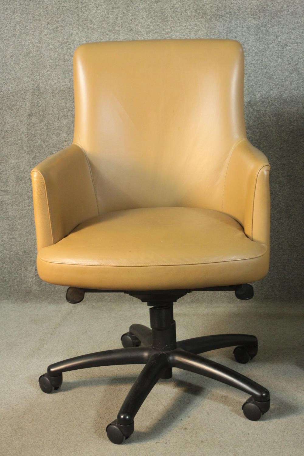 A pair of late 20th century tan leather swivel office chairs, of tub form, with a five point base on - Image 3 of 9