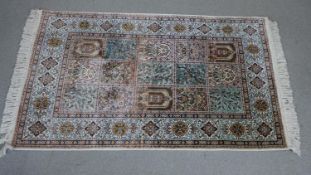 A handmade pink ground Persian silk Kum rug. L.130 H.78cm