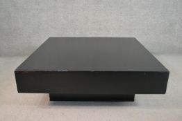 A contemporary black coffee table of square form on a square base. H.40 W.120 D.120cm