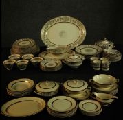 A Johnson Brothers Victorian pattern dinner service with gilt bands on a cream ground along with a