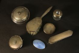 An engine turned decorated silver dressing table set (two brushes, pots and compact) and a guilloche