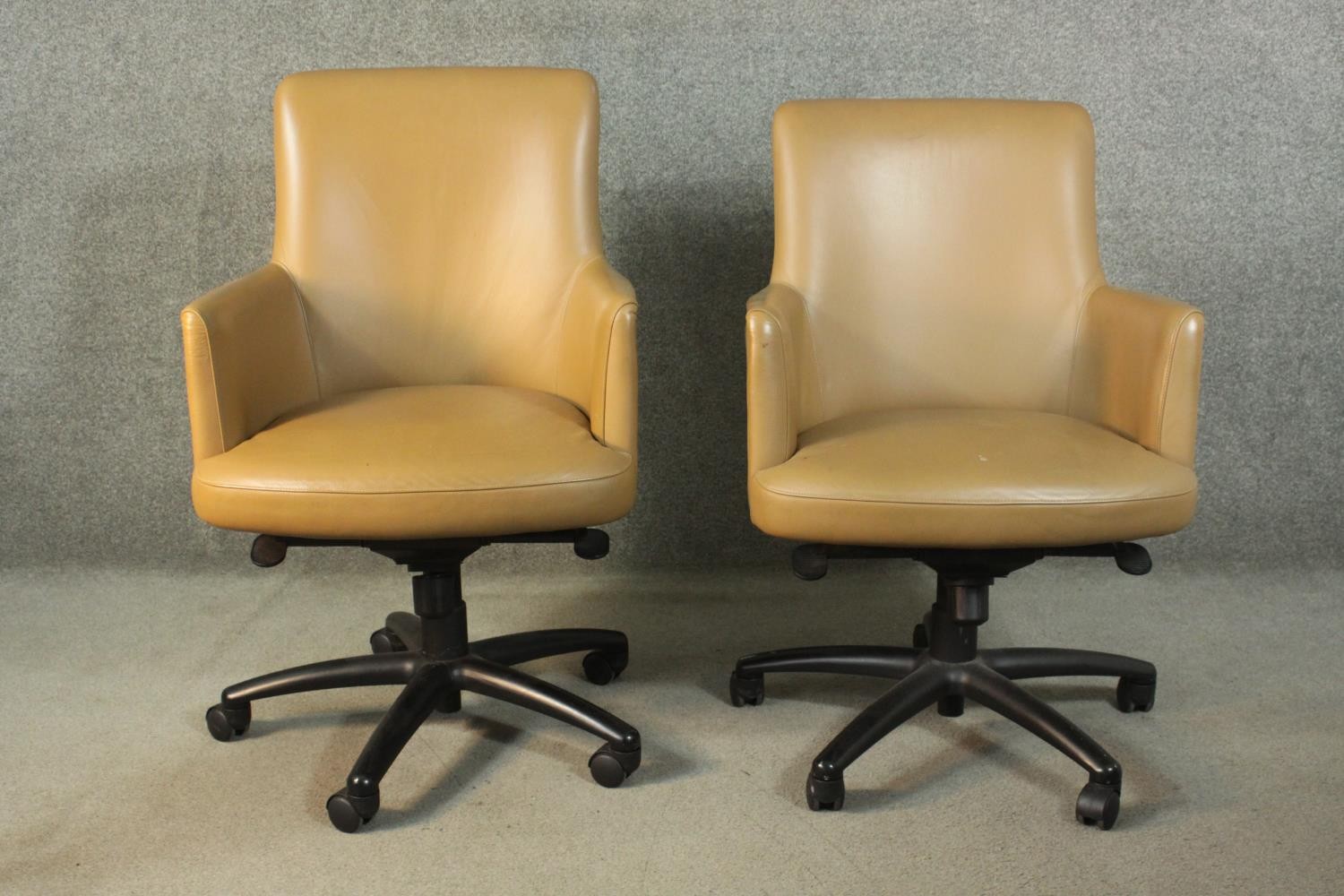 A pair of late 20th century tan leather swivel office chairs, of tub form, with a five point base on - Image 2 of 9