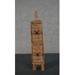 An African tribal carved cabinet of figural form. H.41 W.8.5cm