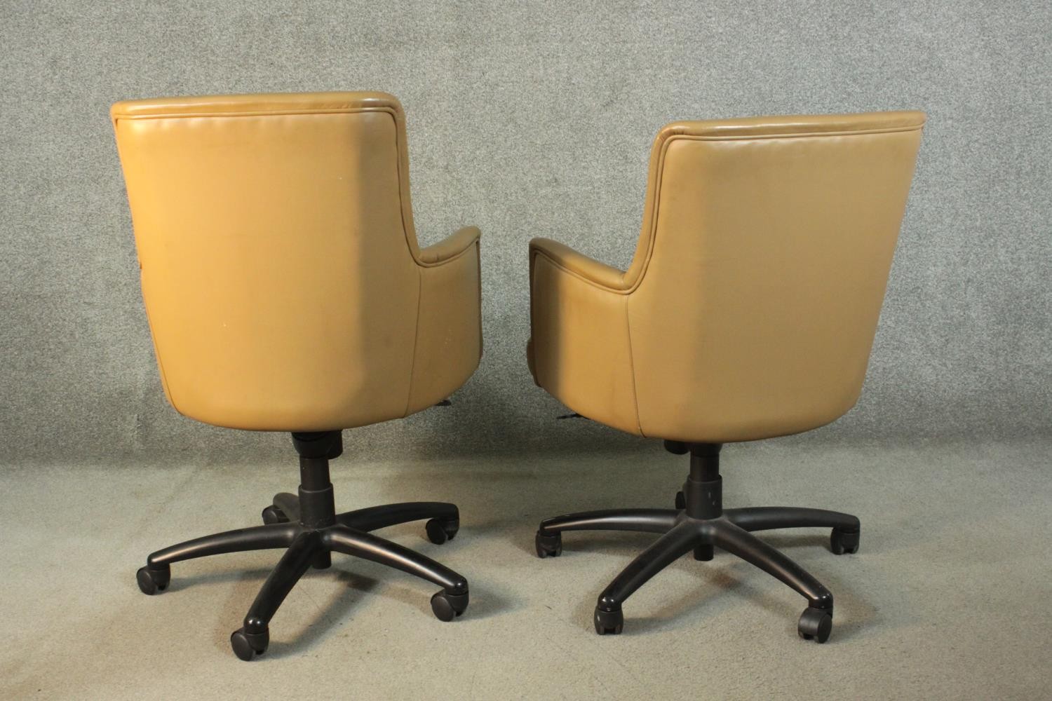 A pair of late 20th century tan leather swivel office chairs, of tub form, with a five point base on - Image 6 of 9