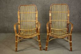 A pair of vintage bamboo and wicker conservatory armchairs.