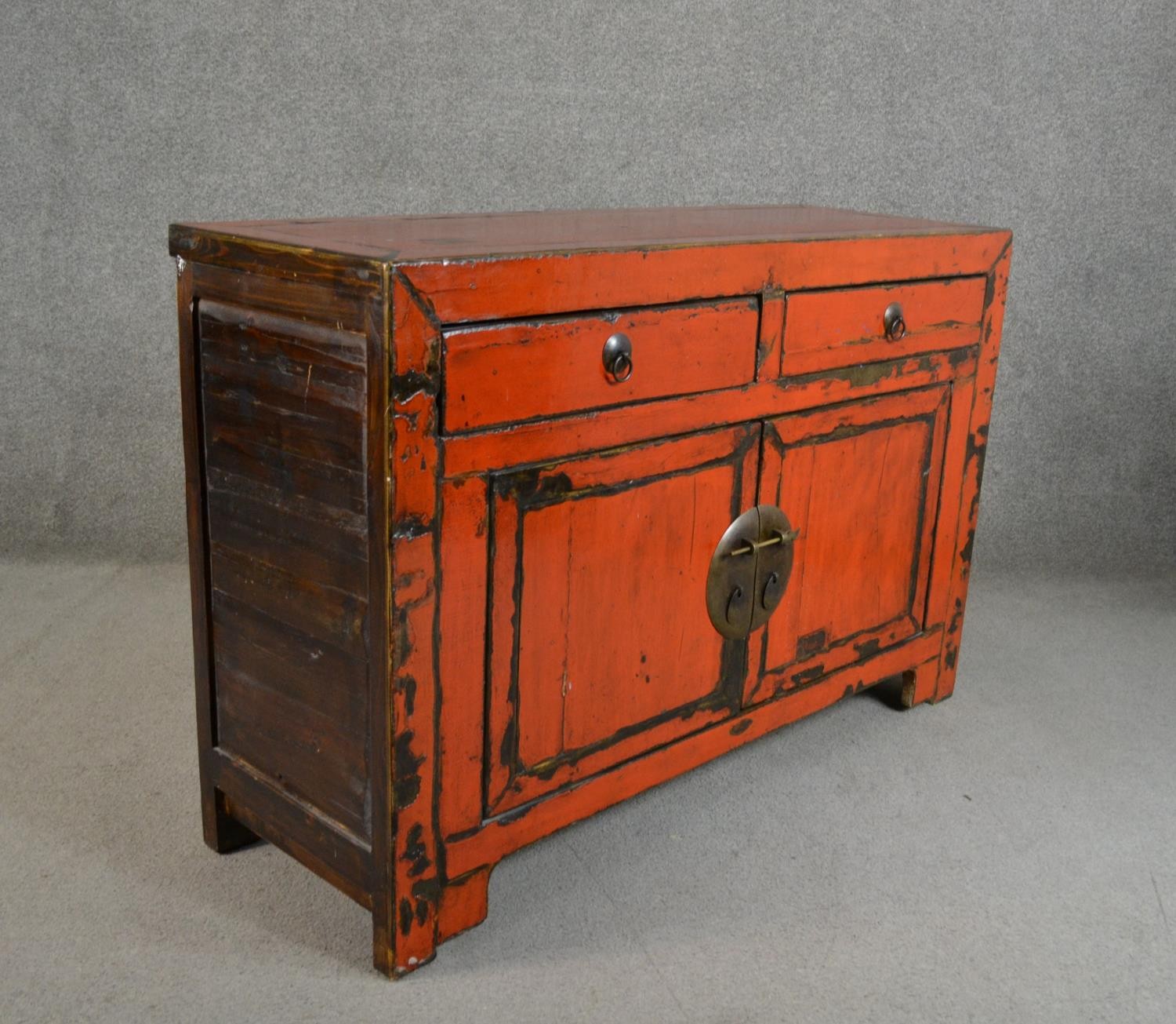 A 20th century Chinese red lacquered sideboard, with two short drawers over two cupboard doors. H.84 - Image 5 of 5