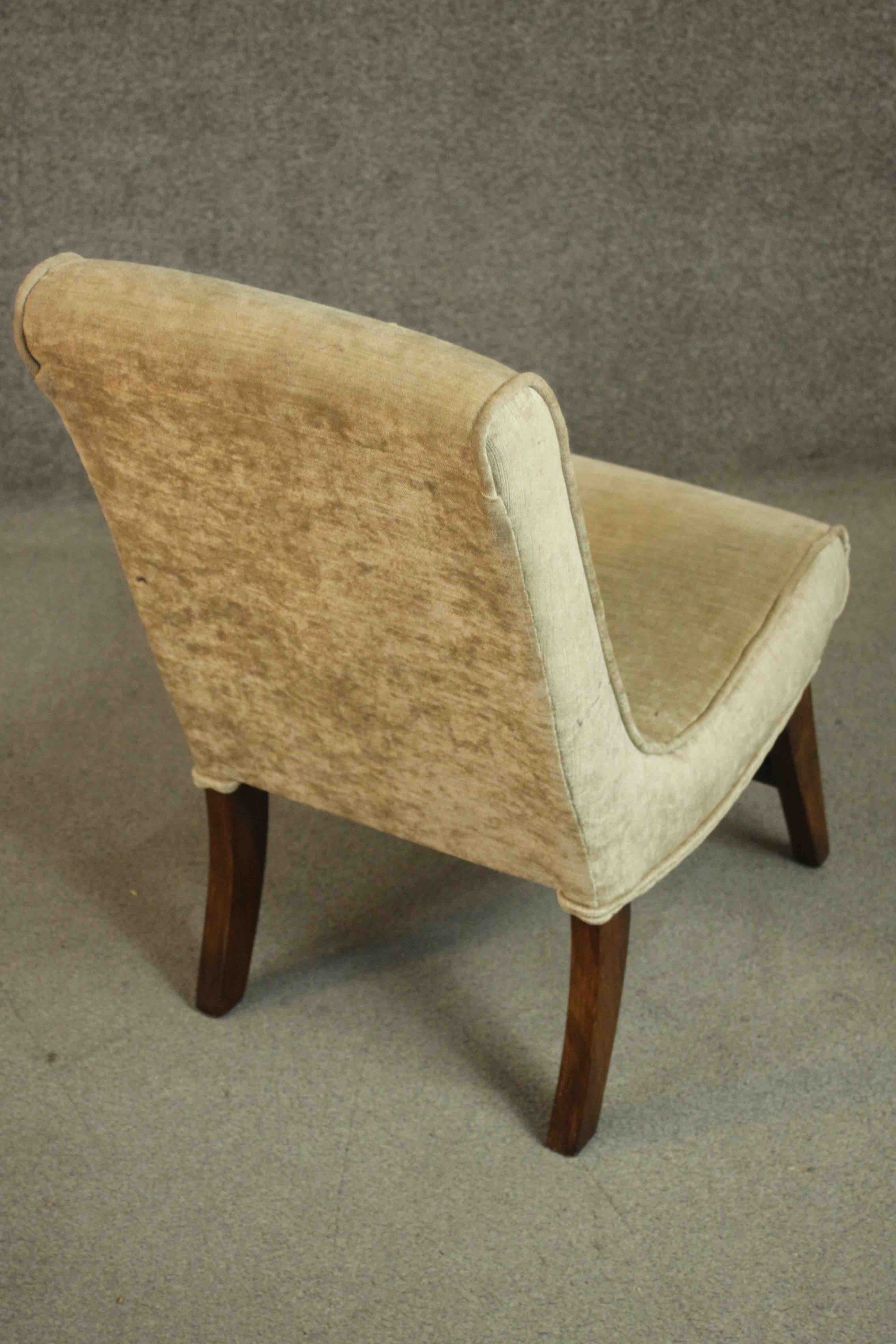 A circa 1960's nursing chair upholstered in gold coloured velour on mahogany legs joined by a - Image 4 of 4