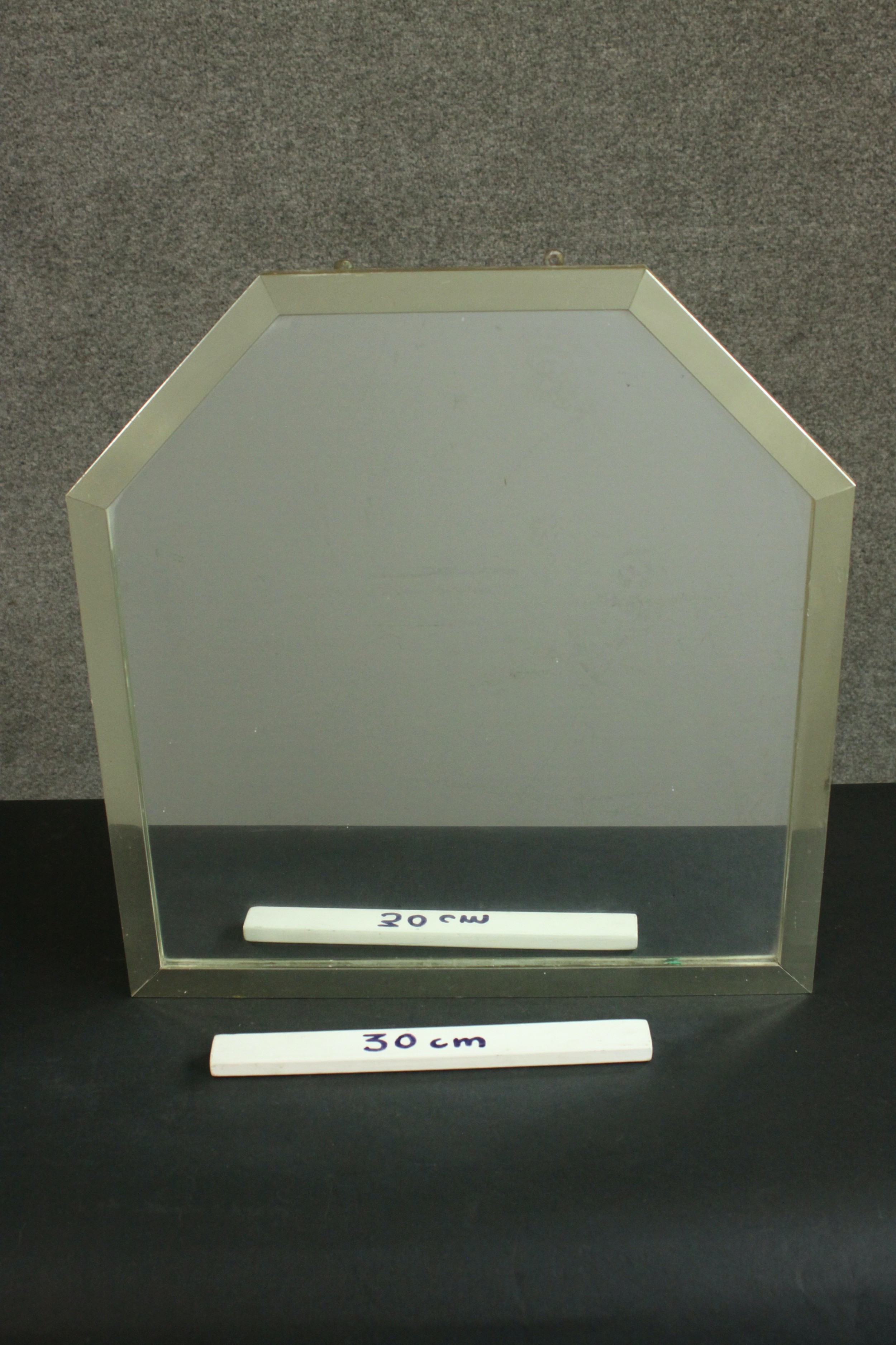 A modernist mirror of square form with canted top corners in a metal frame. H.52 W.50cm. - Image 2 of 4