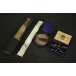 A leather cased 19th century compass along with a boxed slide rule and leather cased set of