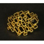 An 18 carat yellow gold mid-century brutalist design openwork brooch. Stamped 750 with S with a line