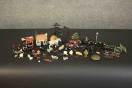 A collection of approximately forty early 20th century painted lead farmyard animals, buildings,