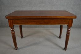 A Victorian walnut tea table of rectangular form with a fold over top on turned legs. H.70 W.116 D.