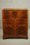 An early 20th century walnut dentists cabinet with a gallery back over a central fall front, flanked