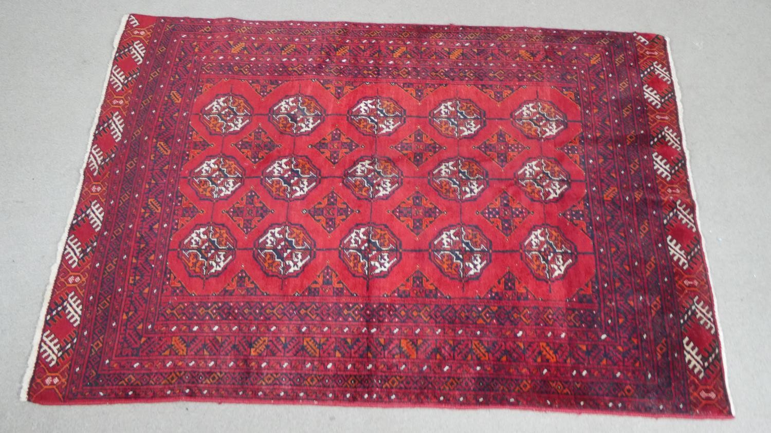 A red ground handmade elephants foot motif Persian Yamut rug. L.153 H.108cm