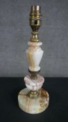A mid 20th century turned onyx table lamp with a baluster stem brass fittings on a circular base.