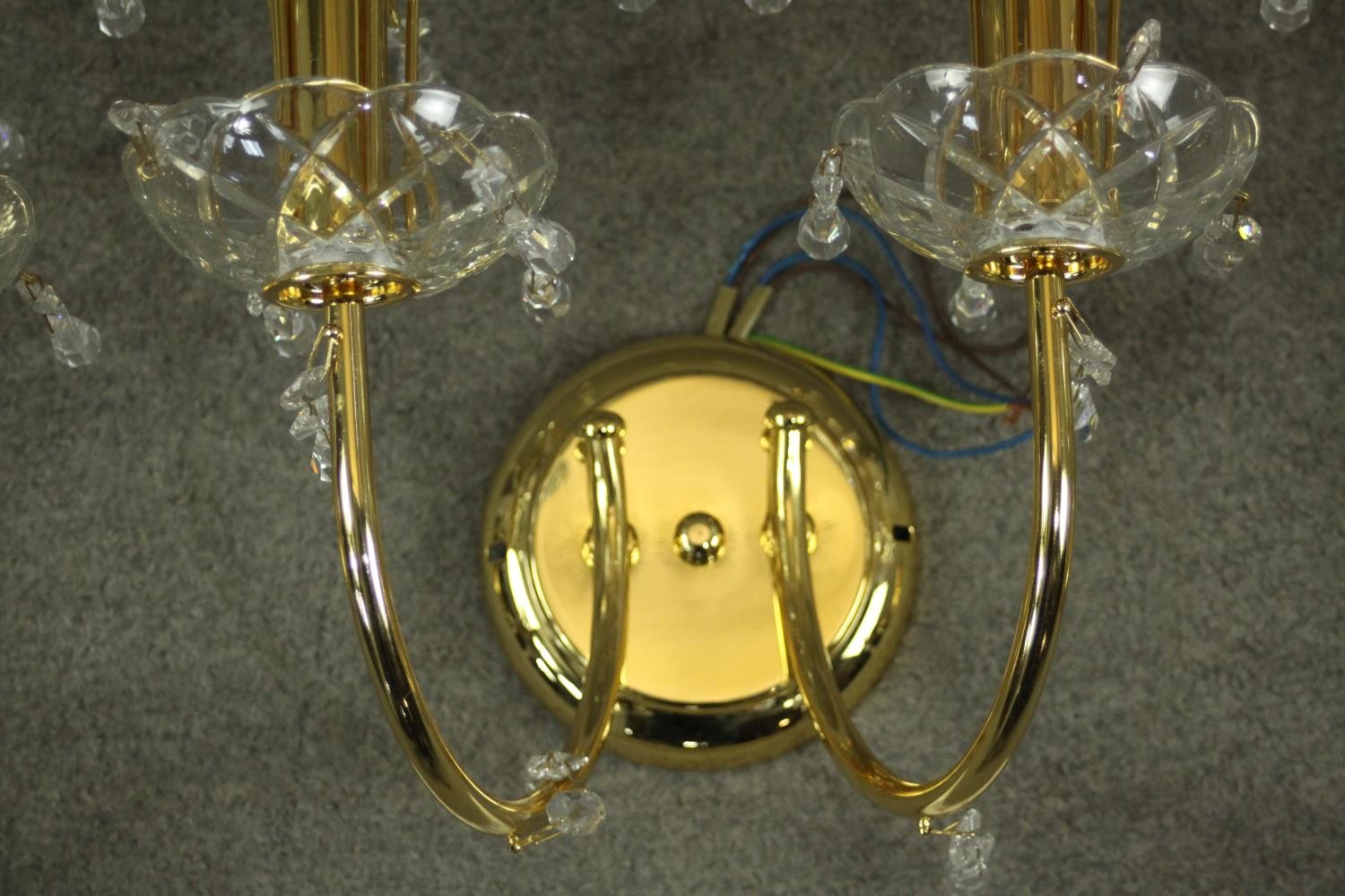 A set of three contemporary gilt brass and Spectra Swarovski crystal two branch wall lights designed - Image 6 of 7