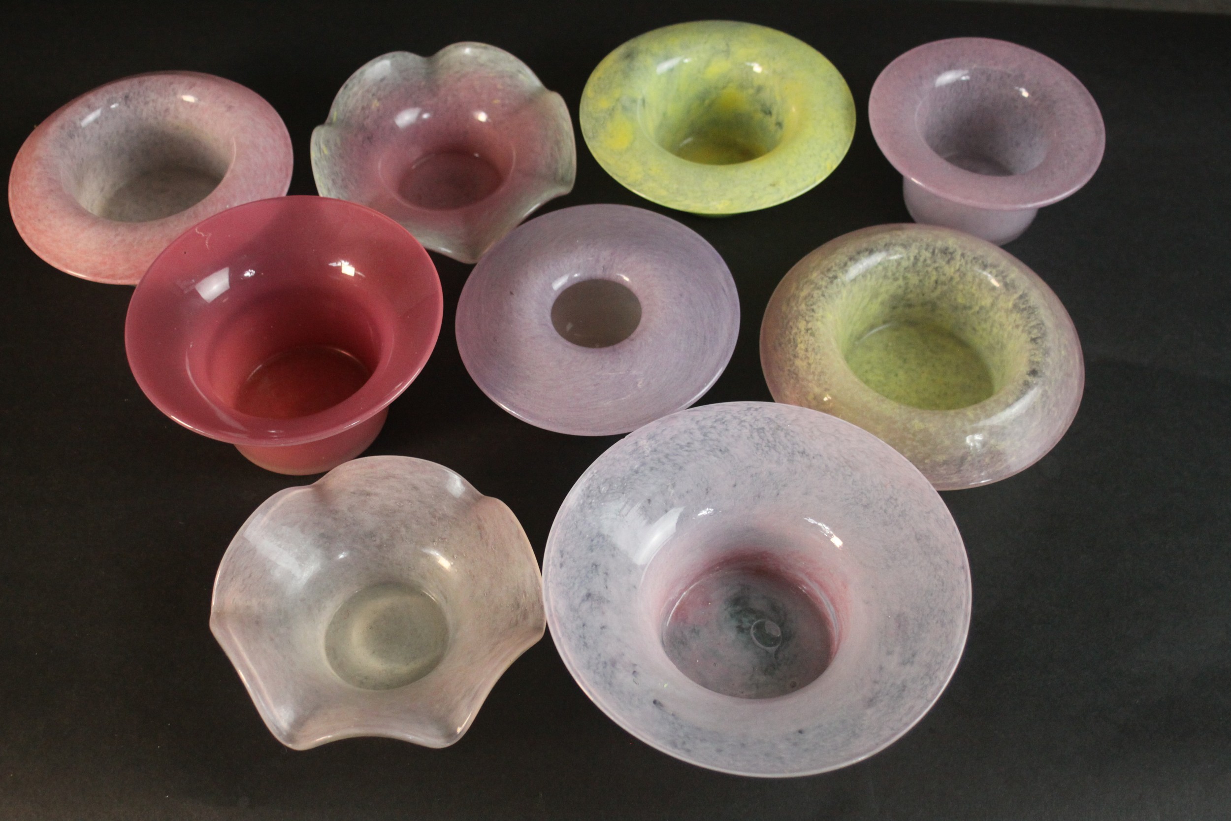 A collection of nine marble pink and yellow art glass dishes. Some signed Vasart. H.6 Dia.16cm.(