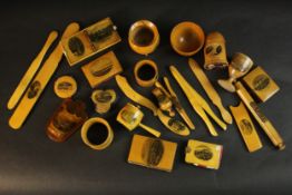 A collection of twenty four early 20th century Mauchline ware souvenir items. Egg cups, letter