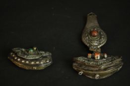 Two 19th century Tibetan white metal and brass purses. One inset with chunks of coral and the