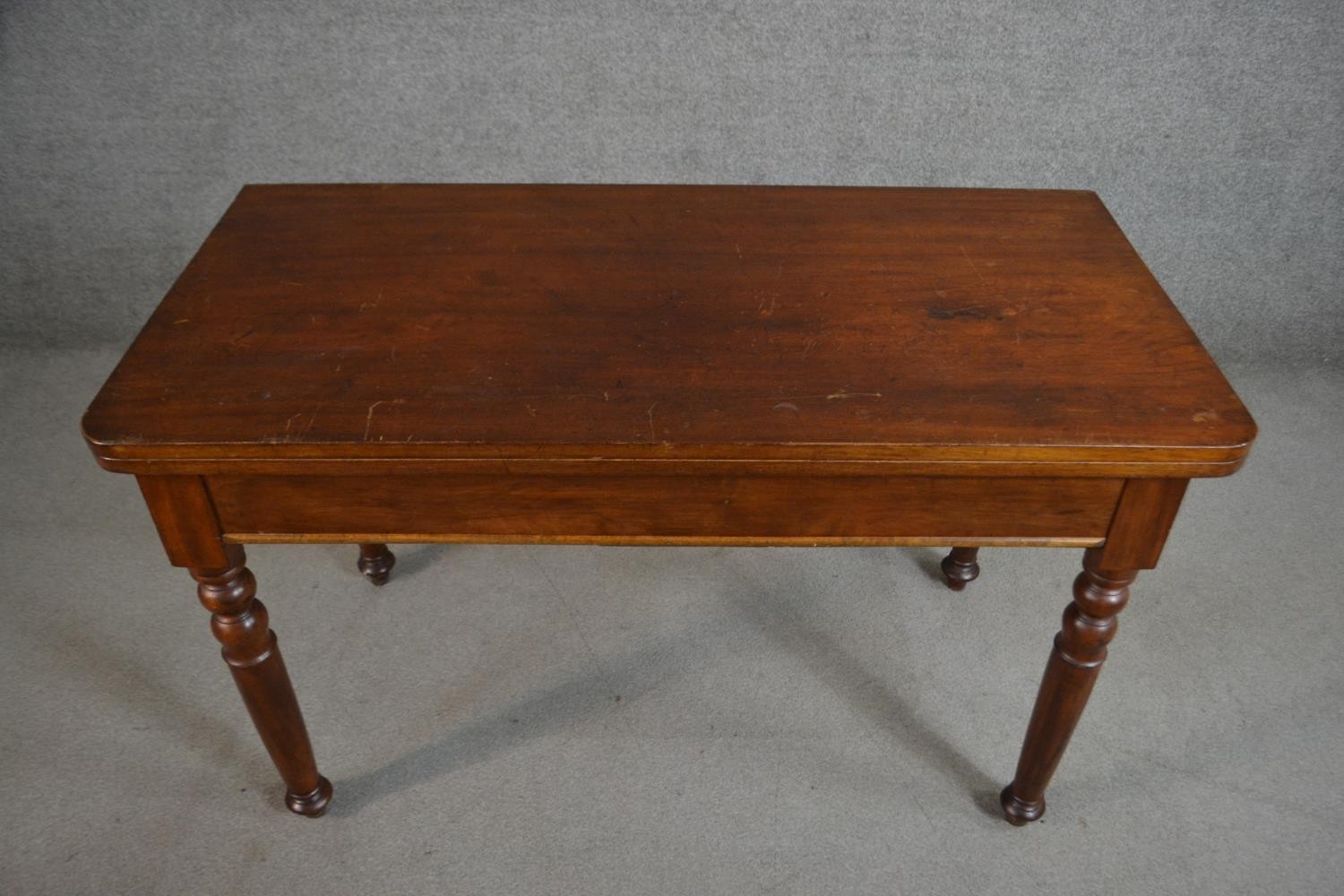 A Victorian walnut tea table of rectangular form with a fold over top on turned legs. H.70 W.116 D. - Image 2 of 6
