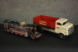 A vintage Tri-ang tipper truck and a similar tinplate locomotive. H.15 W.39 D.12cm. (largest)