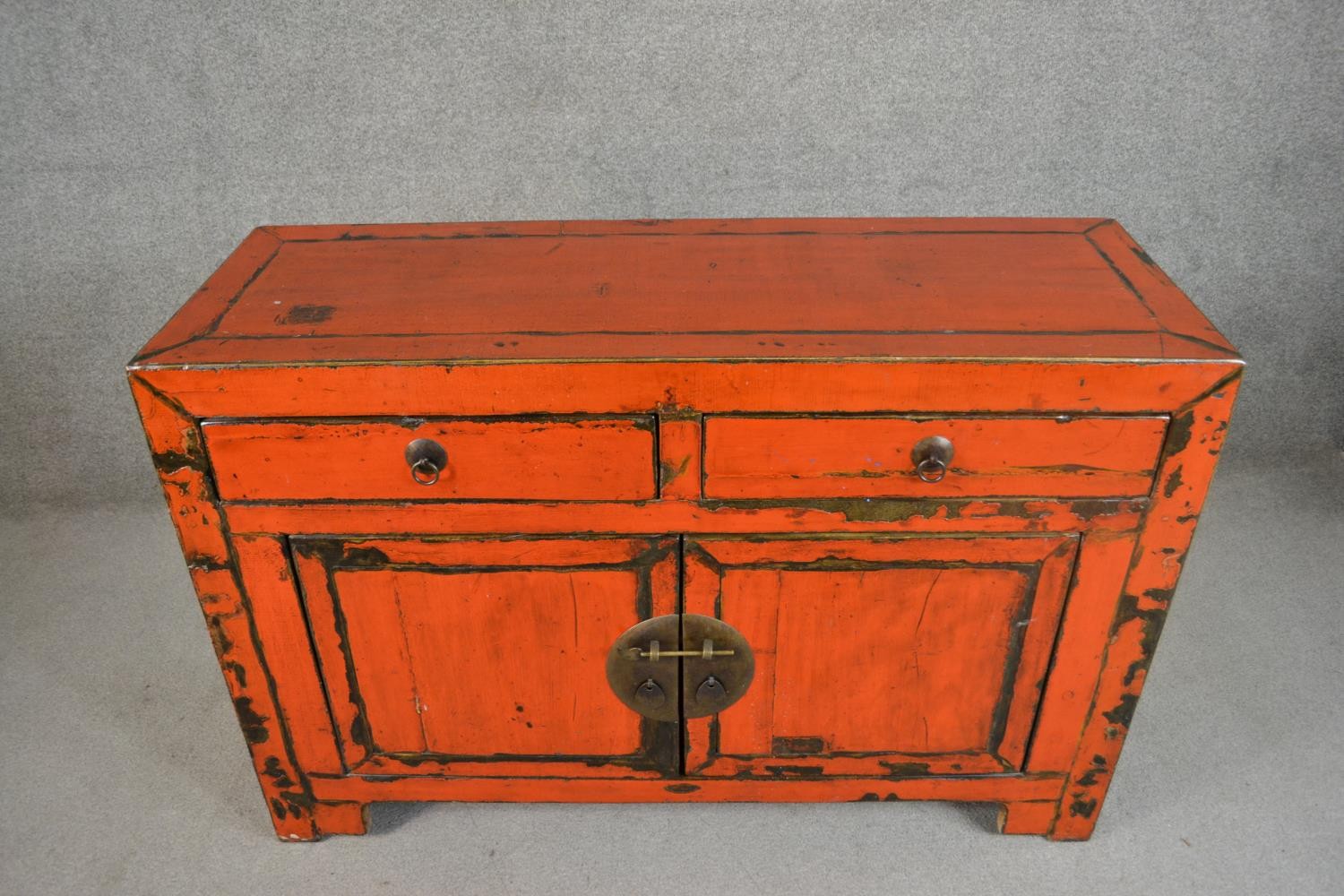 A 20th century Chinese red lacquered sideboard, with two short drawers over two cupboard doors. H.84 - Image 2 of 5